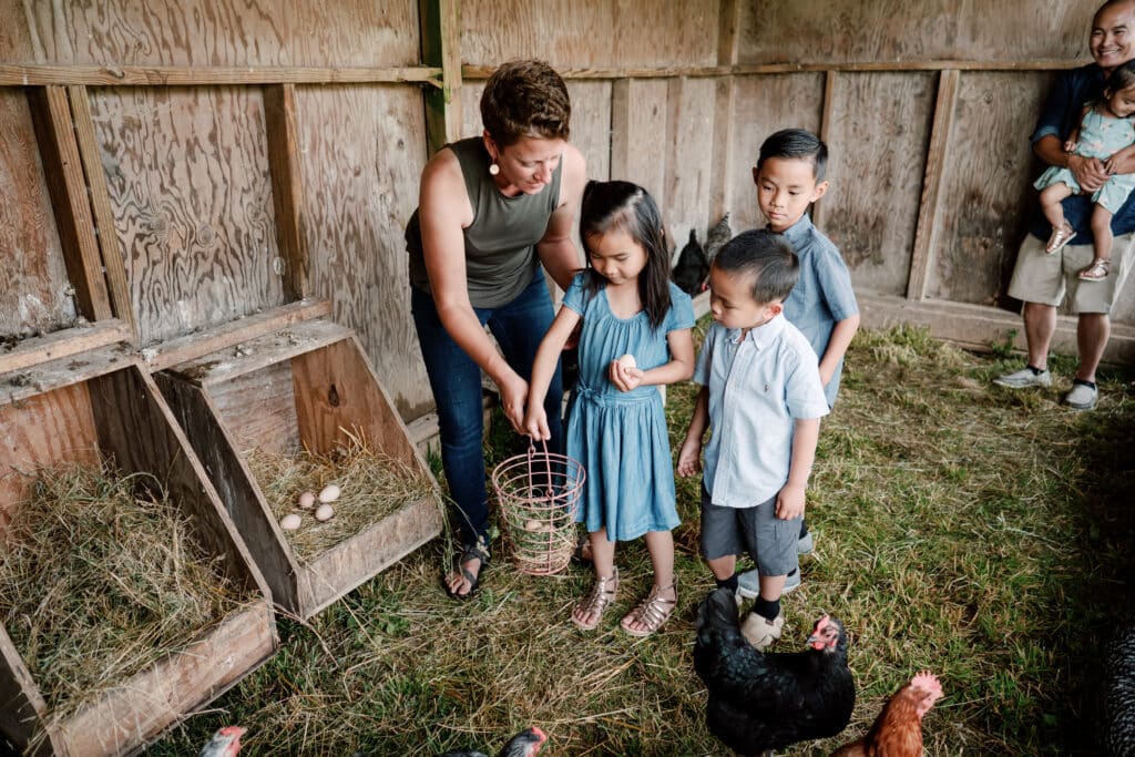 Lancaster Attractions You Can't Miss This Summer 8 Young children collect eggs from the chicken coop with Farmer Elisa. A farm stay is a great lodging choice after experiencing Lancaster attractions.